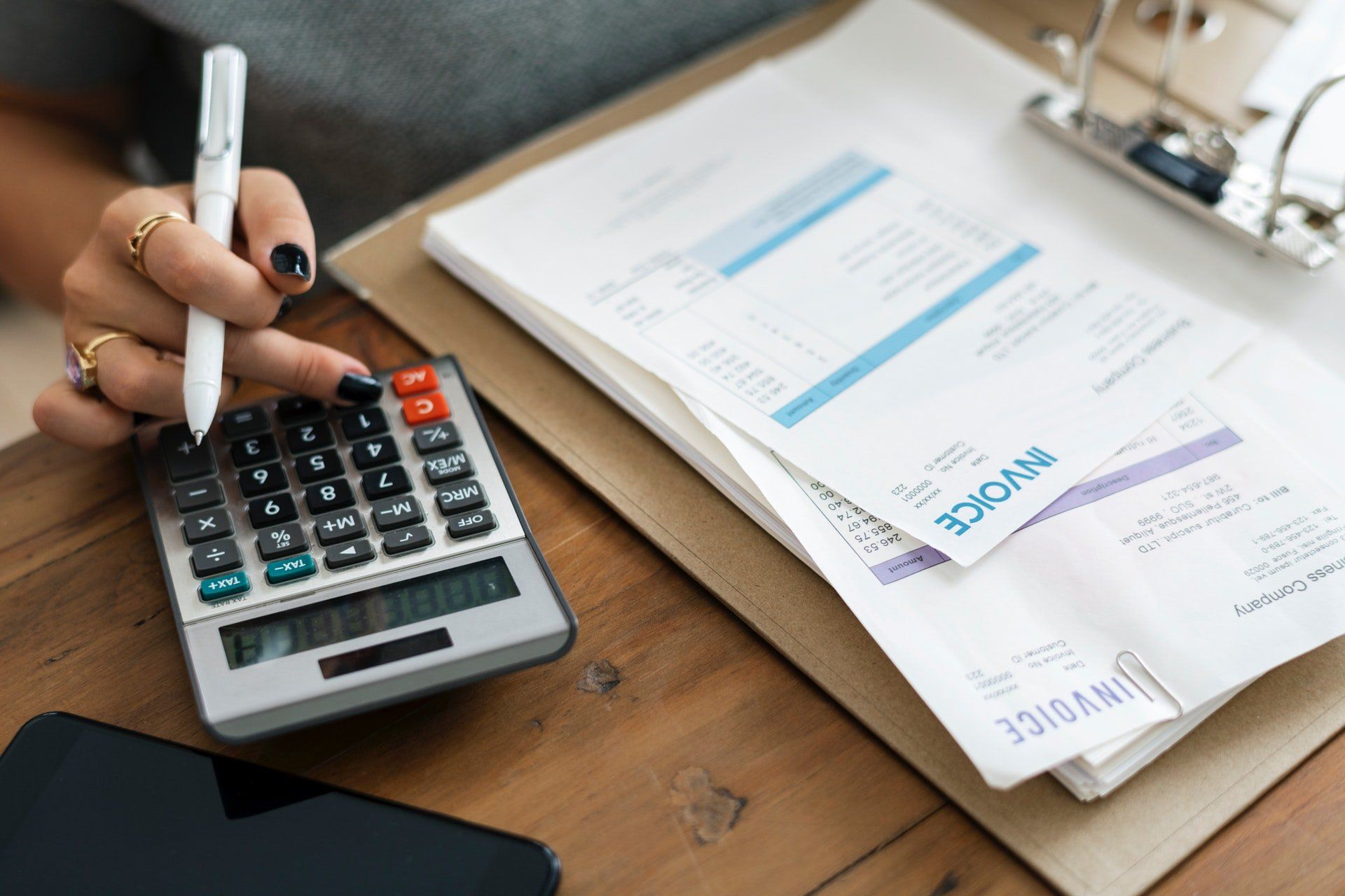 Calculator and financial paperwork on a bookkeeper's desk