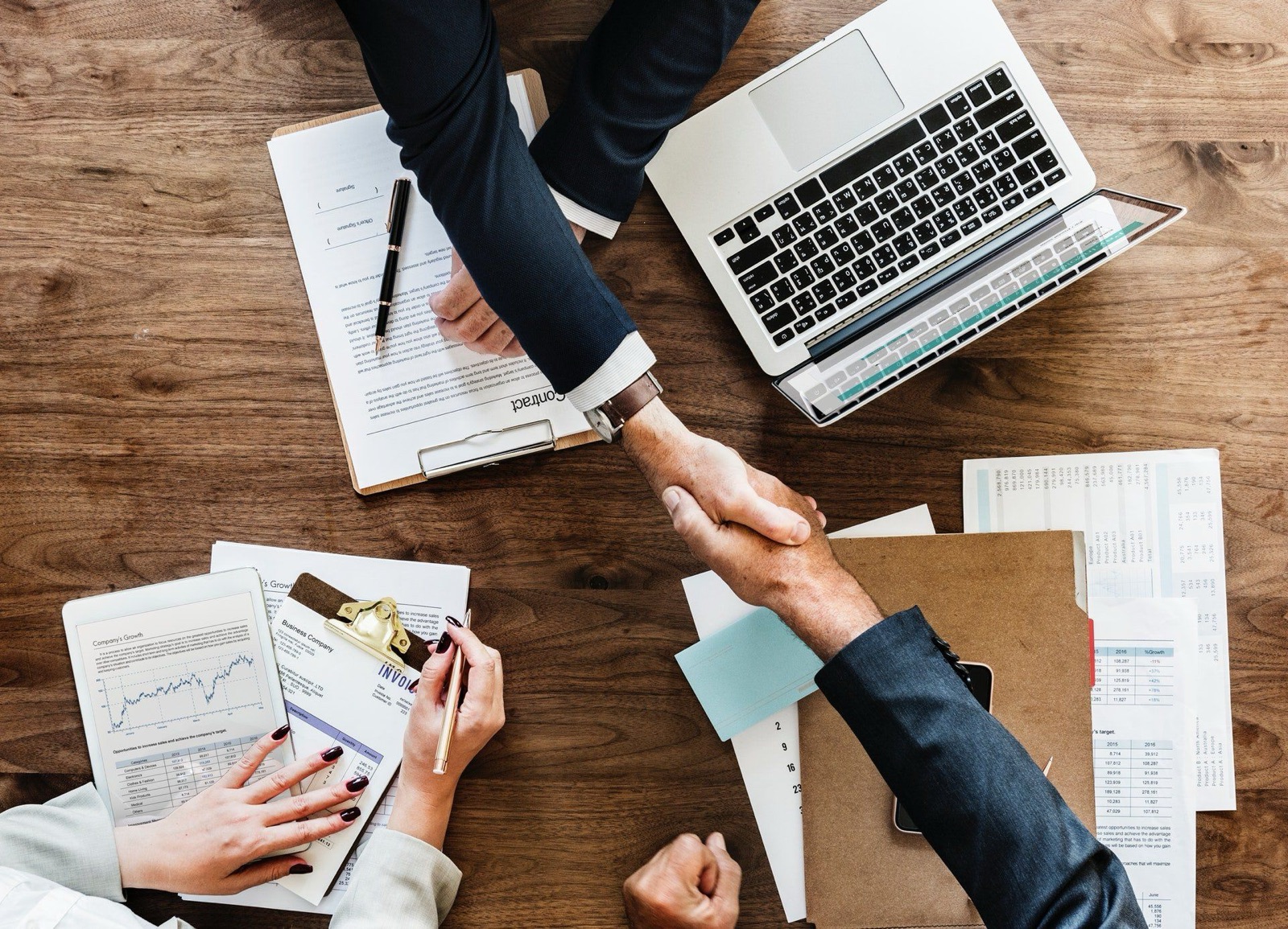 Two businessmen reviewing plans together at a desk